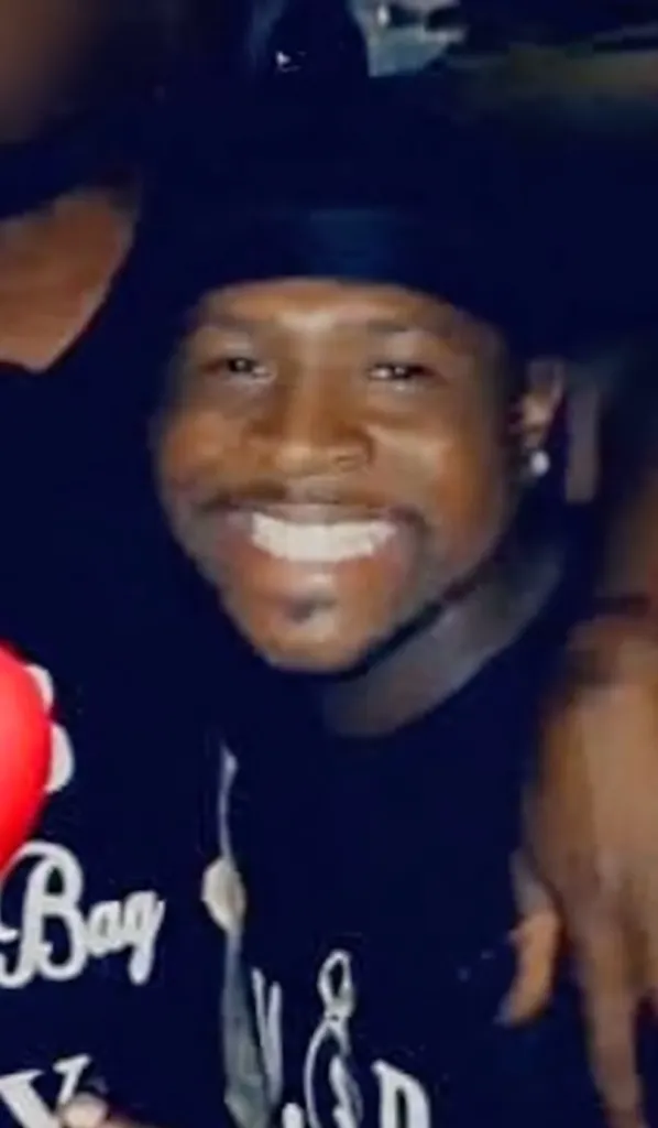 Jarmon Mattix smiling while wearing a black shirt and hat.