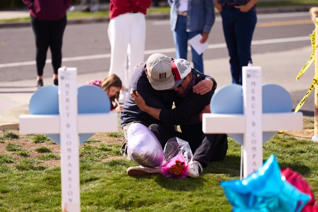 Community members embracing outside Silver Rail Elementary School in Bend, Oregon.