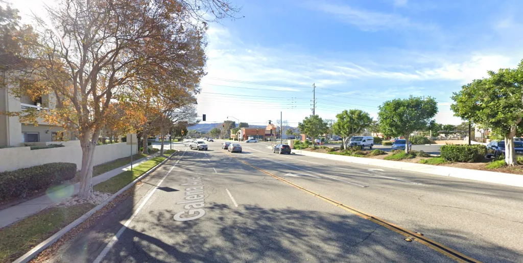 A daytime street view of Galena Avenue in Simi Valley, showing multi-lane roads, trees lining the sides, and buildings in the background under a blue sky.