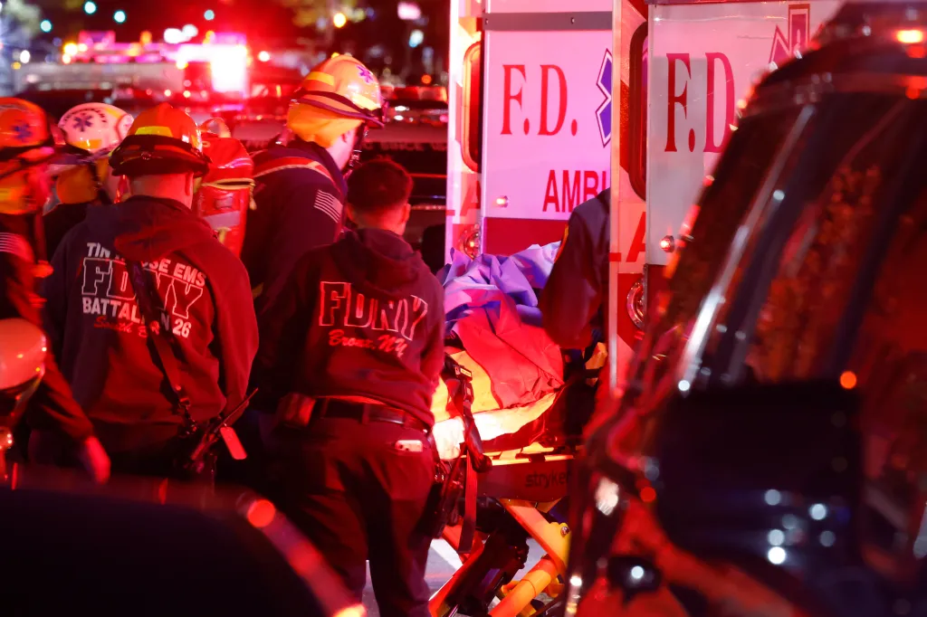 Emergency personnel loading a victim into an FDNY ambulance at a shooting scene in the Bronx.