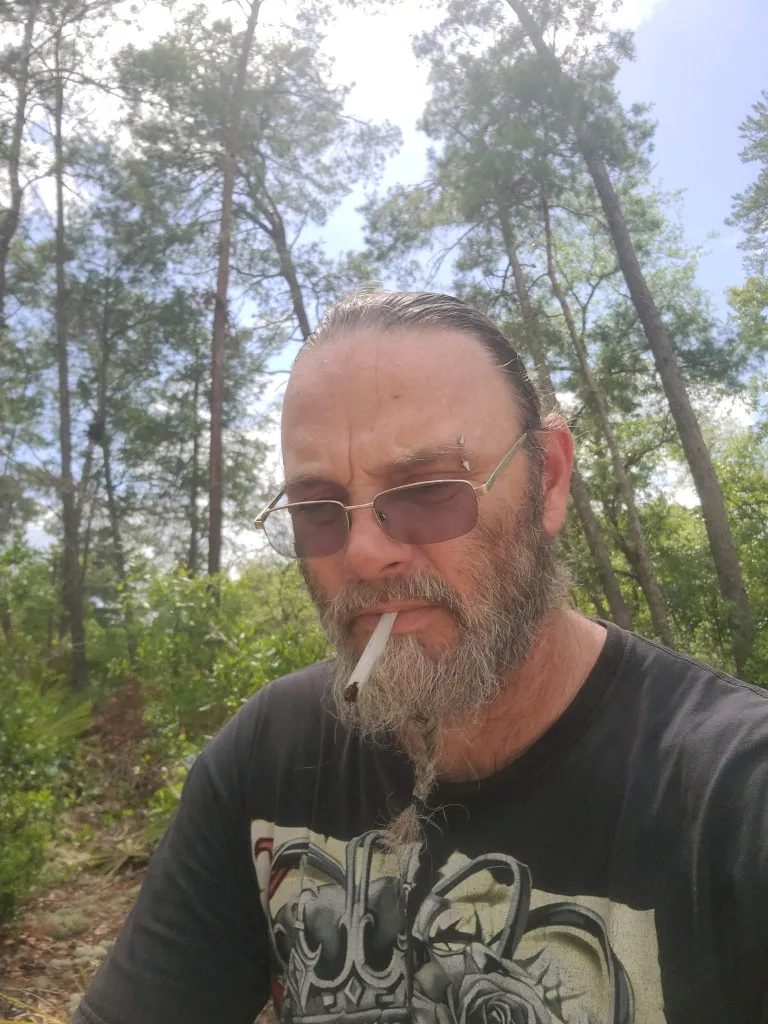 Dwain Hall outdoors with a cigarette.